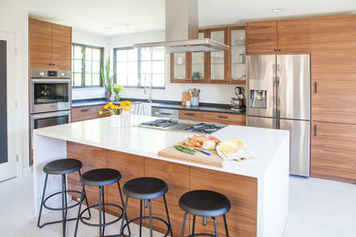 Inspiration for a midcentury open plan kitchen in San Francisco with a farmhouse sink, flat-panel cabinets, medium wood cabinets, quartz benchtops, multi-coloured splashback, ceramic splashback, stainless steel appliances, porcelain floors, with island and white floor.