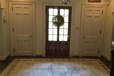 Inspiration for a mid-sized transitional dark wood floor entryway remodel in Houston with beige walls and a red front door