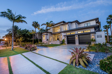 This is an example of a modern front yard driveway in Tampa with concrete pavers.