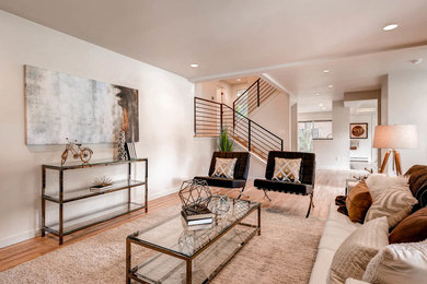 Living room - contemporary open concept medium tone wood floor living room idea in Denver with beige walls, no fireplace and no tv