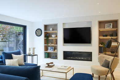 This is an example of a medium sized contemporary formal and cream and black enclosed living room feature wall in London with white walls, light hardwood flooring, a wood burning stove, a wall mounted tv and beige floors.