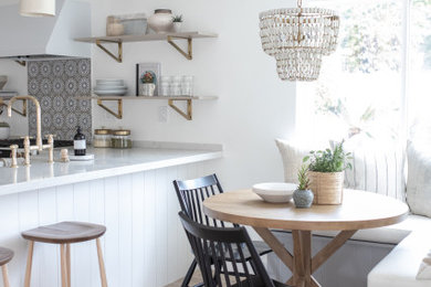 Inspiration for a mid-sized transitional l-shaped kitchen remodel in Orange County with shaker cabinets and an island