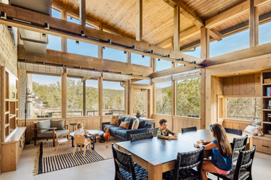 Mountain style beige floor, vaulted ceiling, wood ceiling and wood wall family room photo in Other with beige walls