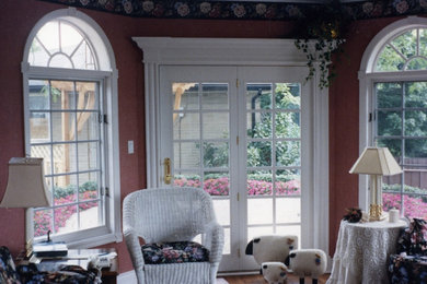 Inspiration for a medium tone wood floor living room remodel in Toronto with red walls