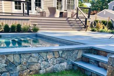 Inspiration for a mid-sized timeless backyard stone and rectangular natural pool landscaping remodel in Boston