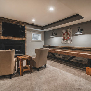 Inspiration for a large rustic look-out basement in Columbus with grey walls, carpet, a ribbon fireplace and a metal fireplace surround.