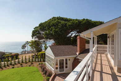 Inspiration for a mid-sized transitional beige two-story wood gable roof remodel in Los Angeles