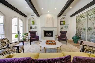 Transitional medium tone wood floor, brown floor and exposed beam living room photo in Houston with white walls and a standard fireplace
