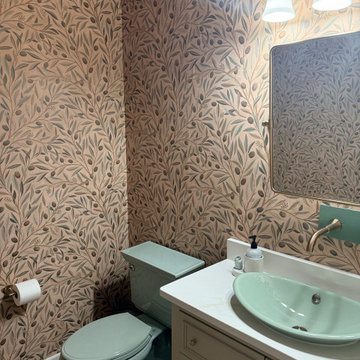 Eclectic Powder Room with Botanical Wallpaper and Green Fixtures