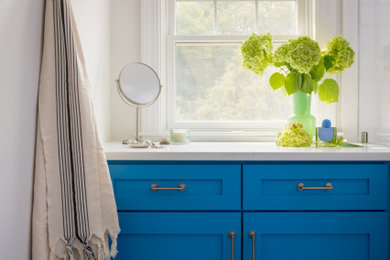 Large beach style master white tile and porcelain tile porcelain tile, multicolored floor, double-sink and wallpaper bathroom photo in Boston with shaker cabinets, blue cabinets, a bidet, white walls, an undermount sink, quartz countertops, a hinged shower door, white countertops and a built-in vanity