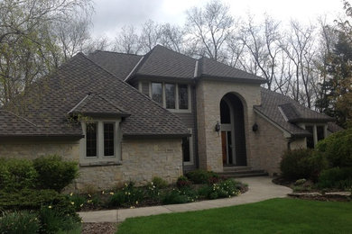 Traditional three-story stone exterior home idea in Columbus