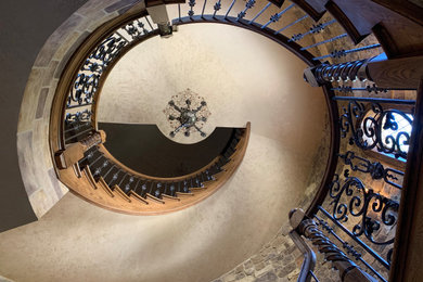 Inspiration for a large rustic wooden curved mixed material railing staircase remodel with wooden risers