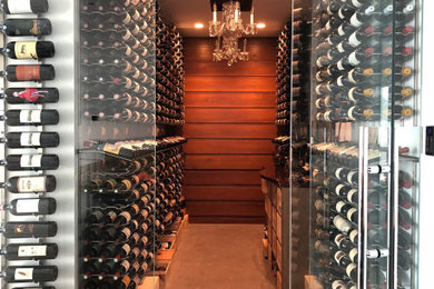 Example of a large transitional concrete floor wine cellar design in New York with storage racks