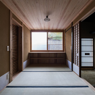 京都の片開きドア和風のおしゃれな玄関ラウンジ (ベージュの壁、畳、木目調のドア) の写真