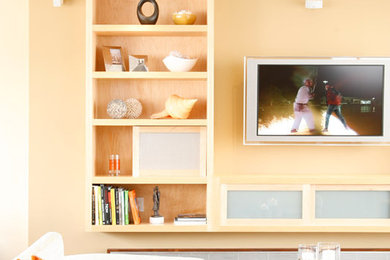 Inspiration for a mid-sized contemporary open concept dark wood floor living room remodel in San Francisco with beige walls, no fireplace and a wall-mounted tv