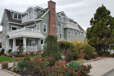 Huge transitional green three-story vinyl exterior home idea in Philadelphia