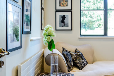 Inspiration for a mid-sized transitional built-in desk carpeted and beige floor study room remodel in Hertfordshire with beige walls