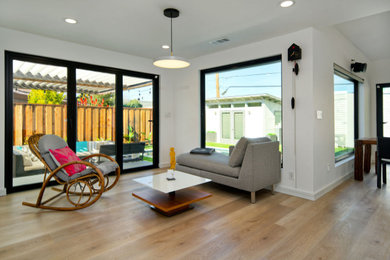 Inspiration for a contemporary medium tone wood floor living room remodel in San Francisco with white walls
