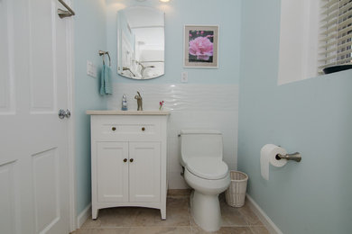 Inspiration for a contemporary bathroom in DC Metro with shaker cabinets, white cabinets, white tile, ceramic tile, blue walls, porcelain floors, an undermount sink, engineered quartz benchtops, beige floor and beige benchtops.