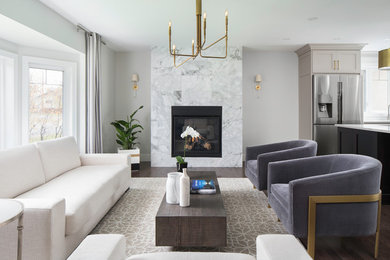 Photo of a mid-sized transitional open concept living room in Calgary with dark hardwood floors, a standard fireplace, a stone fireplace surround and no tv.