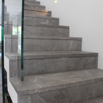 Modern gray marble stairs with crossing glass