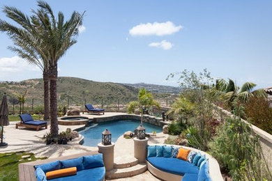 Beach style patio photo in Orange County with a fire pit and no cover
