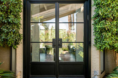 Example of a trendy entryway design in Austin with beige walls and a glass front door