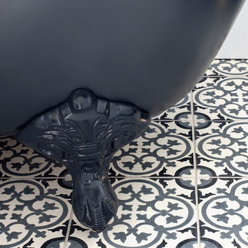 Dark grey-floored wetroom with encaustic flooring and freestanding bath - Hove