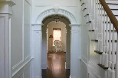 Inspiration for a small timeless dark wood floor hallway remodel in New York with white walls