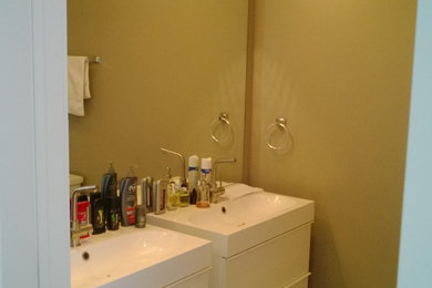 Mid-sized minimalist master white tile and ceramic tile ceramic tile bathroom photo in Chicago with an integrated sink, flat-panel cabinets, white cabinets, quartz countertops, a two-piece toilet and beige walls