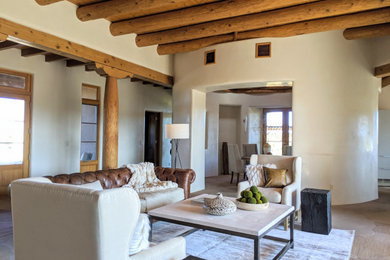 Inspiration for a large southwestern formal and open concept living room remodel in Other with beige walls, a standard fireplace, a stone fireplace and no tv