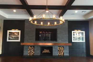 Home theater - huge modern open concept dark wood floor and brown floor home theater idea in Orlando with gray walls and a media wall