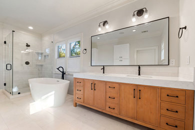 Bathroom - large transitional master white tile and marble tile marble floor, white floor and double-sink bathroom idea in Austin with shaker cabinets, brown cabinets, a two-piece toilet, white walls, an undermount sink, quartz countertops, a hinged shower door, white countertops and a freestanding vanity