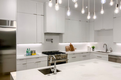 Eat-in kitchen - large modern single-wall medium tone wood floor and brown floor eat-in kitchen idea in Austin with an undermount sink, flat-panel cabinets, white cabinets, quartz countertops, white backsplash, quartz backsplash, stainless steel appliances, an island and white countertops