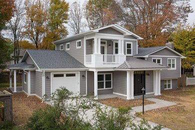 Large eclectic gray three-story vinyl exterior home idea in DC Metro