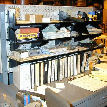 Wall Control industrial tool board being used a book shelf with black tool board