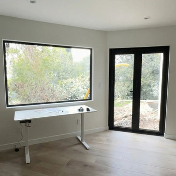 Modern Home Office with Black Aluminum Picture Window and Patio Doors