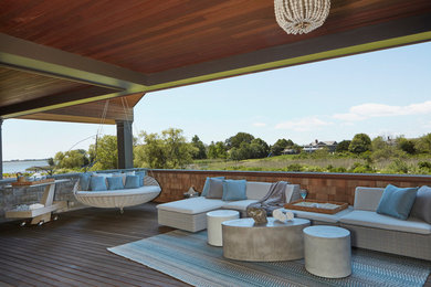 Large trendy deck photo in New York with a roof extension