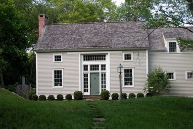 Mid-sized farmhouse gray two-story vinyl gable roof idea in Burlington