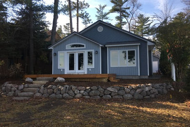Inspiration for a mid-sized craftsman blue one-story vinyl gable roof remodel in Other
