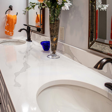 White Bathroom with Envi Quartz Countertops and Curved Tub with Mini Hex Tile