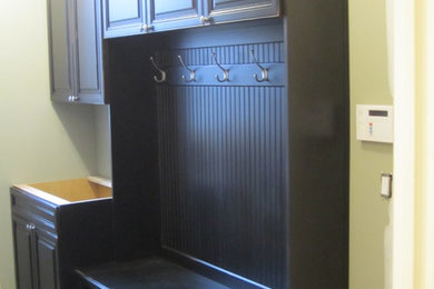 Mid-sized mountain style single-wall dedicated laundry room photo in Detroit with raised-panel cabinets and black cabinets