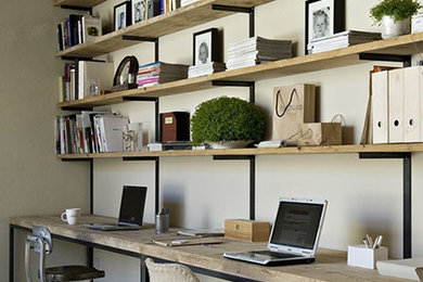 Example of a mid-sized danish built-in desk porcelain tile and brown floor home office design in Chicago with beige walls