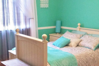 Example of a mid-sized trendy medium tone wood floor bedroom design in Chicago with green walls