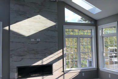 Transitional family room photo in Other with a tile fireplace
