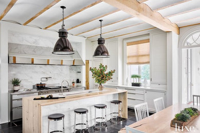 Large country galley slate floor and black floor eat-in kitchen photo in Chicago with an integrated sink, recessed-panel cabinets, white cabinets, wood countertops, white backsplash, stone tile backsplash, stainless steel appliances and an island