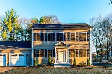 Example of a mid-sized classic beige two-story vinyl exterior home design in Boston