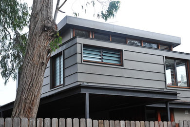 This is an example of a mid-sized contemporary home design in Sydney.