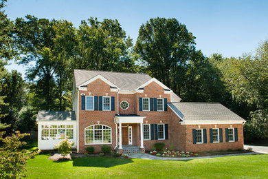 Large elegant red two-story brick gable roof photo in DC Metro