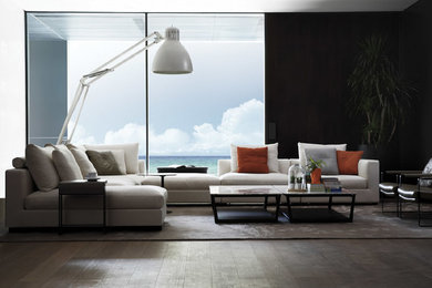 Living room - large modern formal and open concept dark wood floor living room idea in New York with black walls